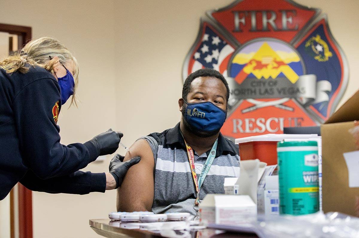 Emergency medical services chief Lisa Price, left, administers a COVID-19 vaccine to North Las ...