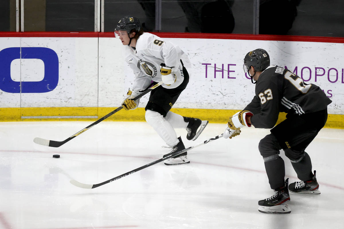 Golden Knights center Cody Glass (9) moves the puck past defenseman Carl Dahlstrom (63) during ...