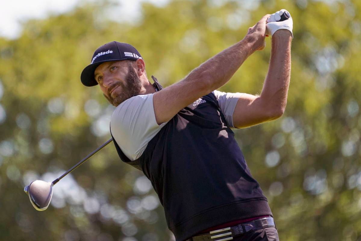 FILE - In this Saturday, Sept. 19, 2020, file photo, Dustin Johnson hits from the fourth tee du ...