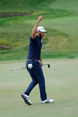 Dustin Johnson reacts after making a birdie putt on the 18th hole during the final round of the ...