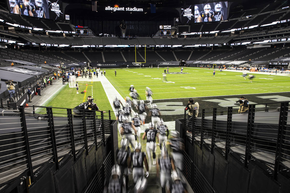 The Raiders take the field at an empty Allegiant Stadium during an NFL football game against th ...