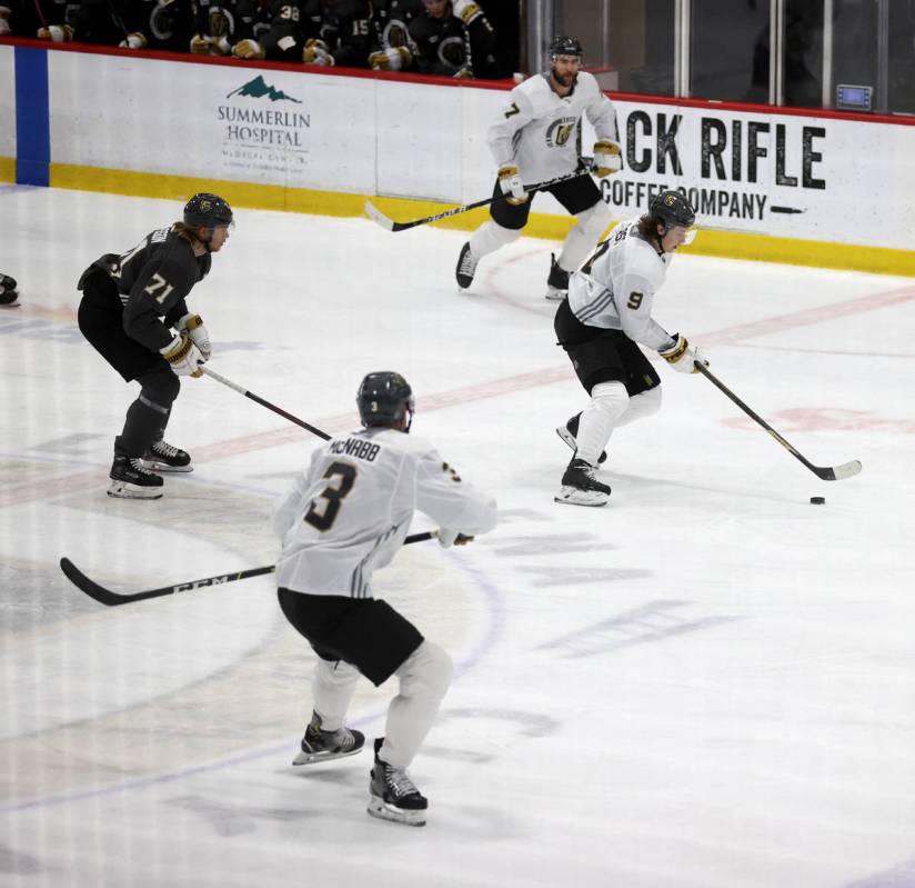 Golden Knights center Cody Glass (9) moves the puck past center William Karlsson (71) as defens ...