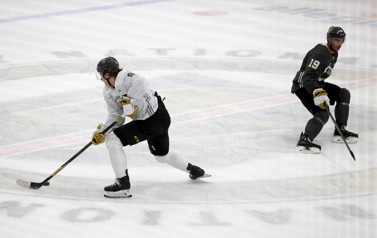 Golden Knights center Cody Glass (9) moves the puck past right wing Reilly Smith (19) during tr ...