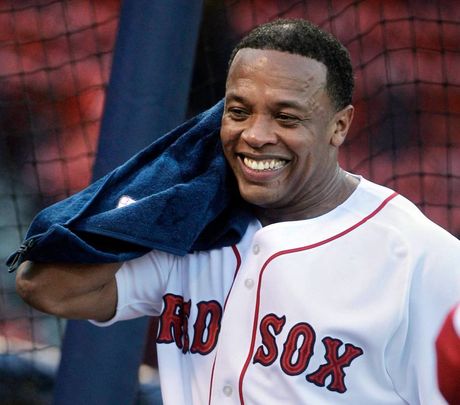 Rapper and producer Dr. Dre towels off after taking batting practice at Fenway Park before the ...