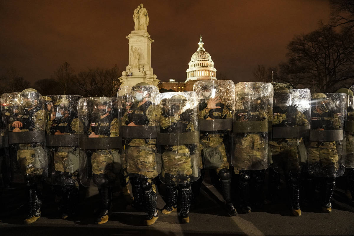 District of Columbia National Guard stand outside the Capitol, Wednesday night, Jan. 6, 2021, a ...