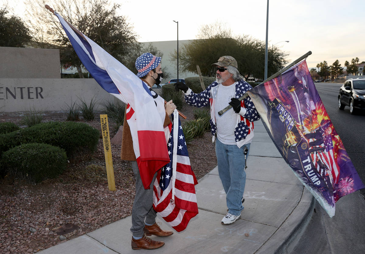 Kevin Abrahami of Las Vegas, a supporter of President-elect Joe Biden, left, argues with a supp ...