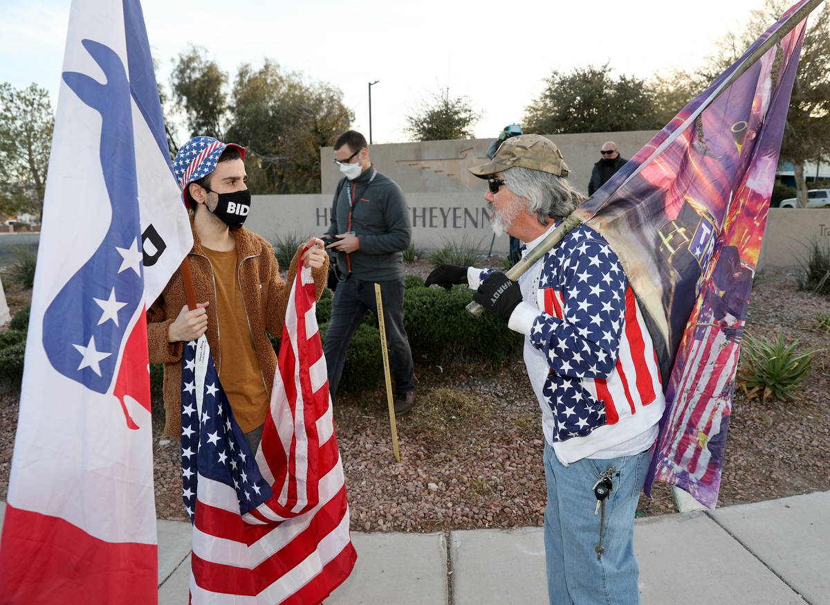 Kevin Abrahami of Las Vegas, a supporter of President-elect Joe Biden, left, argues with a supp ...