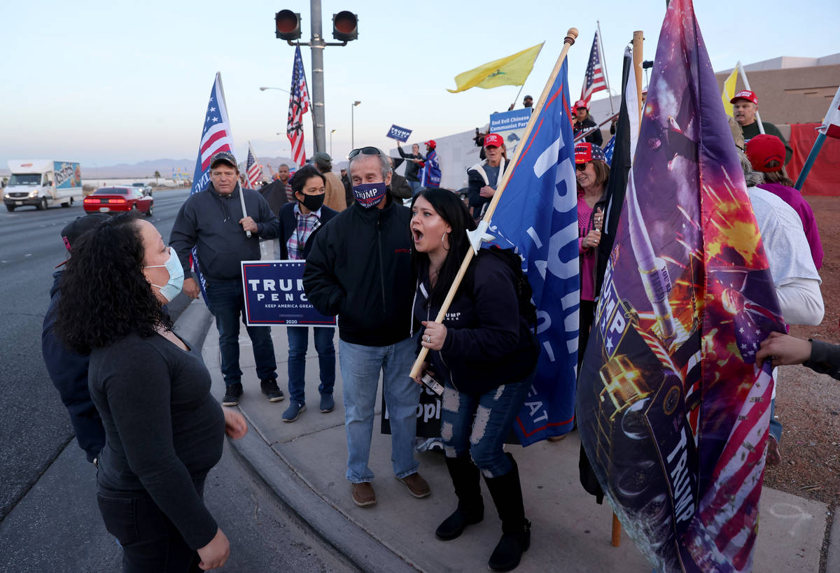 Supporters of President Donald Trump argue with supporters of President-elect Joe Biden during ...