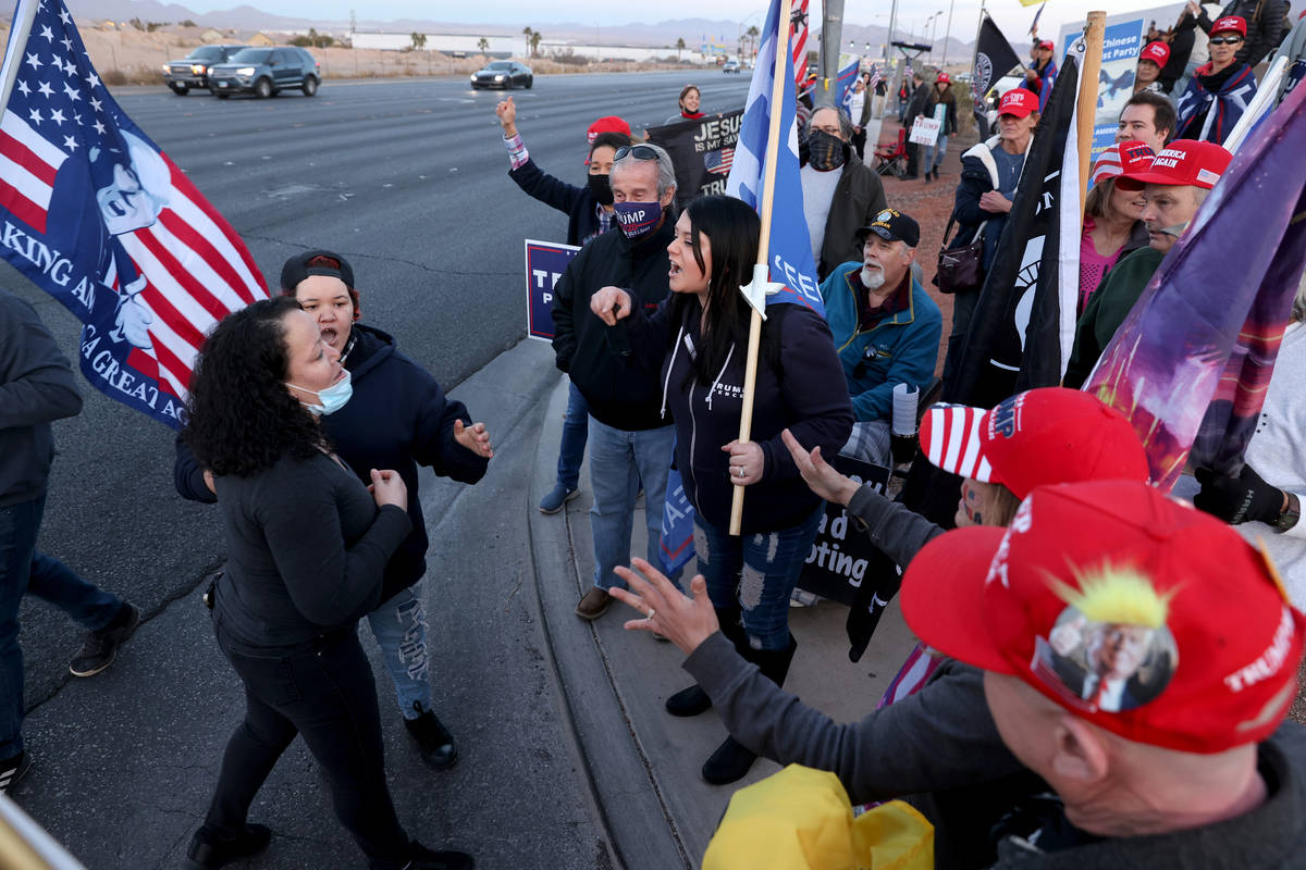 Supporters of President Donald Trump argue with supporters of President-elect Joe Biden during ...