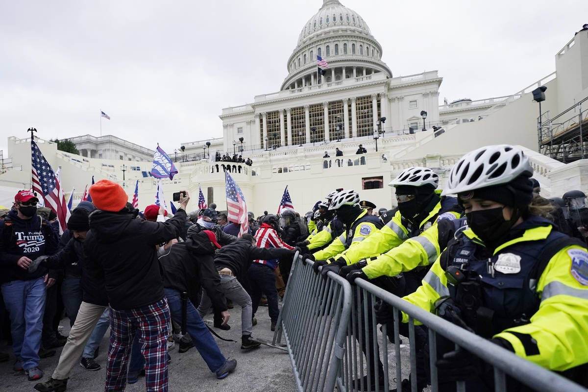 Trump supporters try to break through a police barrier, Wednesday, Jan. 6, 2021, at the Capitol ...