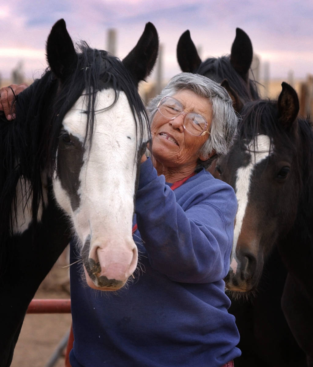 In this Oct. 2, 2002 file photo Carrie Dann works with a horse on the ranch she owns with her s ...