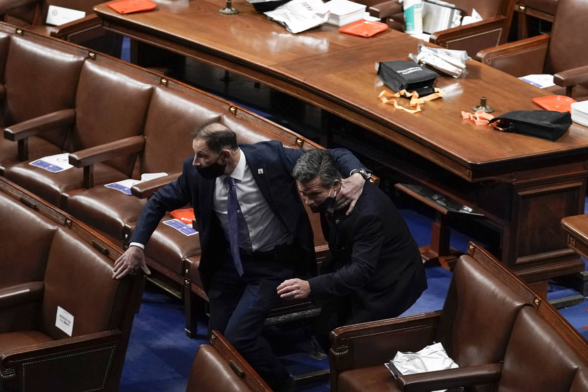 Lawmakers evacuate the floor as protesters try to break into the House Chamber at the U.S. Capi ...