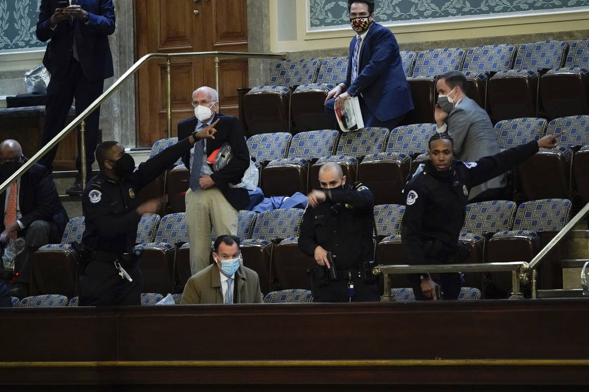 Lawmakers prepare to evacuate the House gallery as protesters try to break into the House Chamb ...