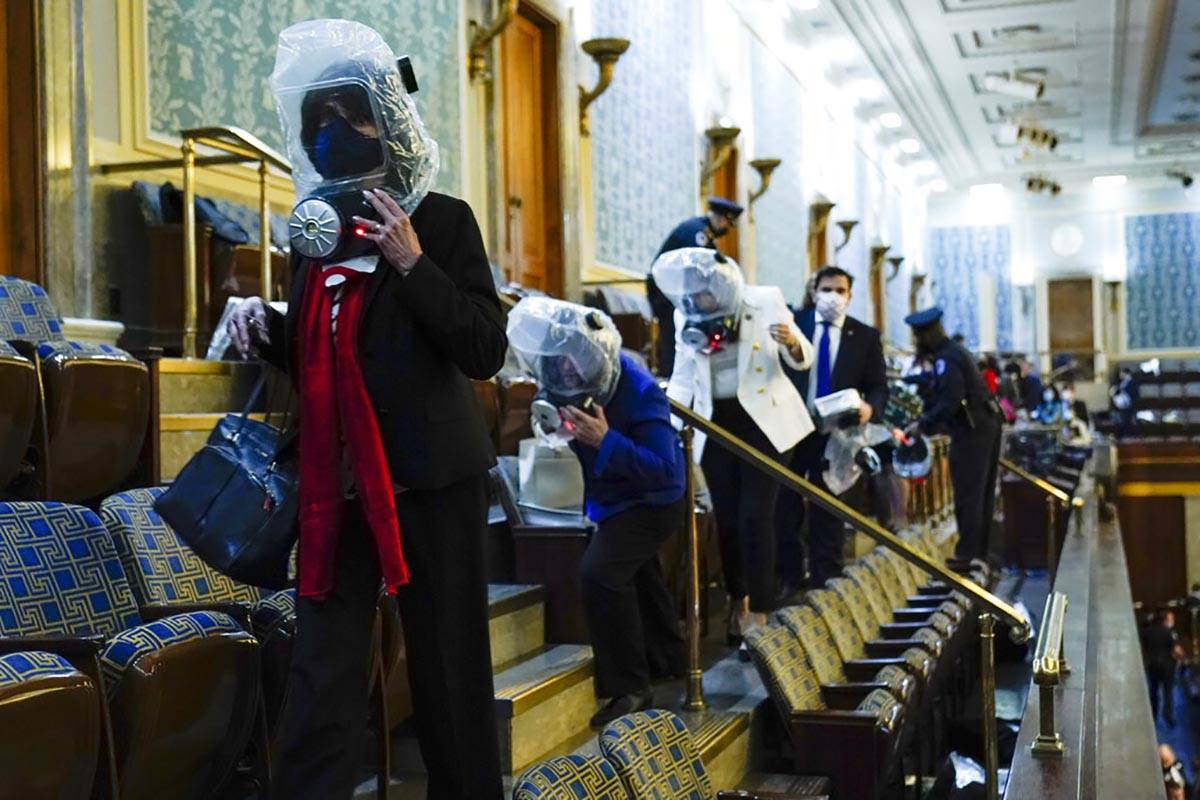 People shelter in the House gallery as protesters try to break into the House Chamber at the U. ...