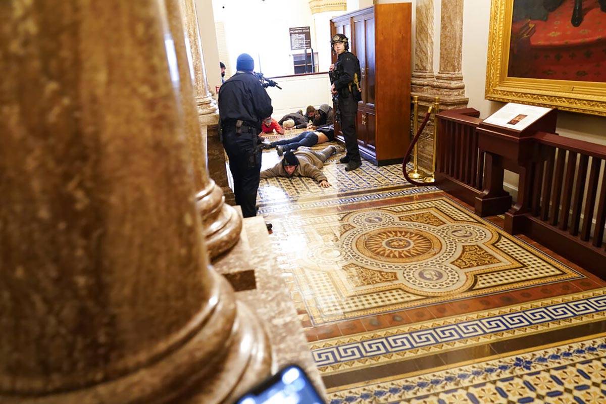 U.S. Capitol Police hold protesters at gun-point near the House Chamber inside the U.S. Capitol ...