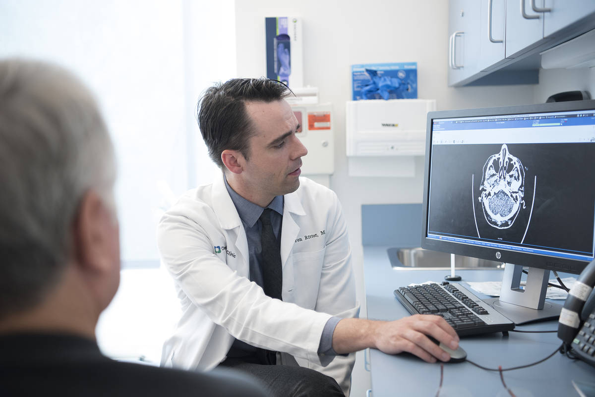 Dr. Aaron Ritter looks at a brain scan of a PABHS participant before the COVID-19 pandemic. (Cl ...
