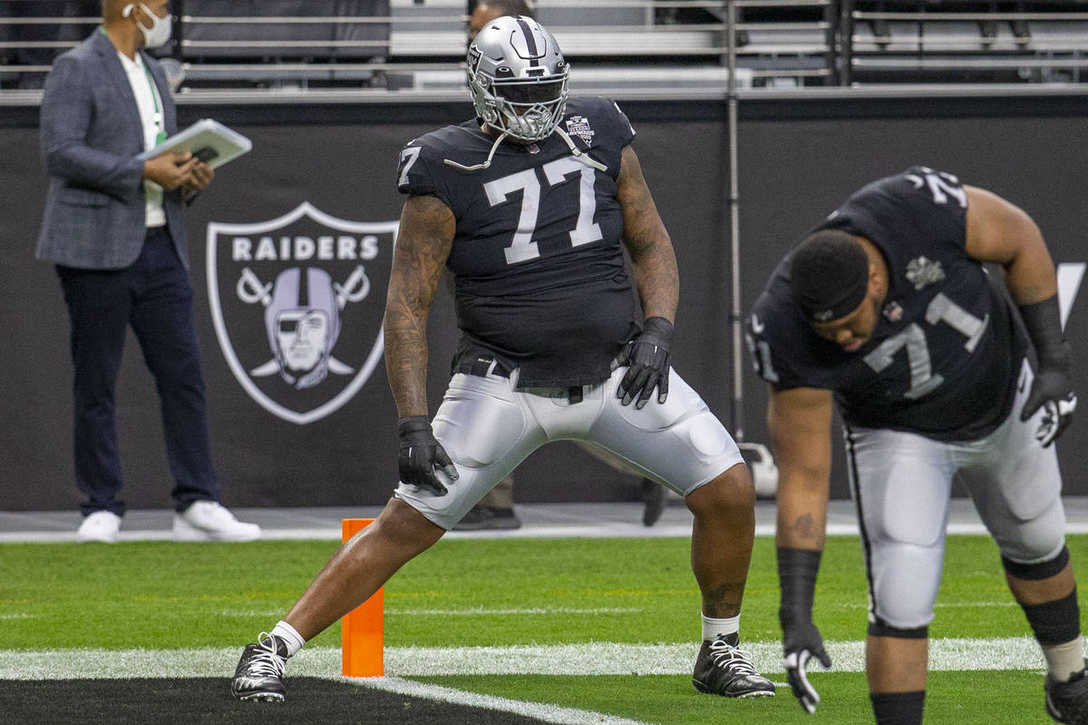 Raiders offensive tackle Trent Brown (77) stretches before an NFL football game against the Ind ...