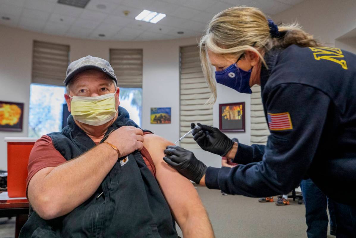 North Las Vegas Fire Department operations Battalion Chief Scott Morris, left, is administrated ...