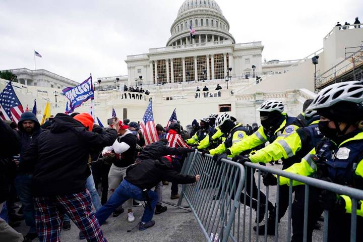 Trump supporters try to break through a police barrier, Wednesday, Jan. 6, 2021, at the Capitol ...