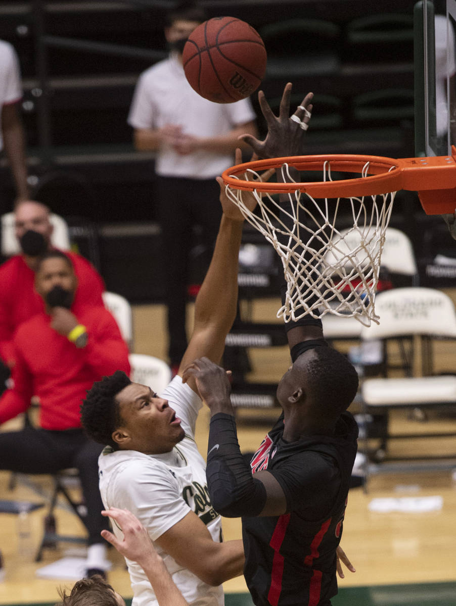 Colorado State forward Dischon Thomas, left, shoots against UNLV during the first half of an NC ...