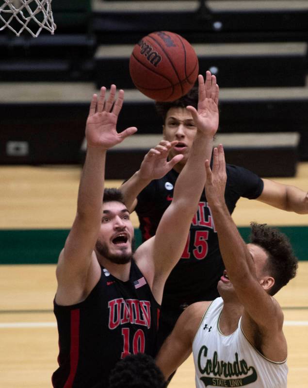 UNLV forward Edoardo Del Cadia, left, blocks a shot from Colorado State guard Isaiah Rivera dur ...