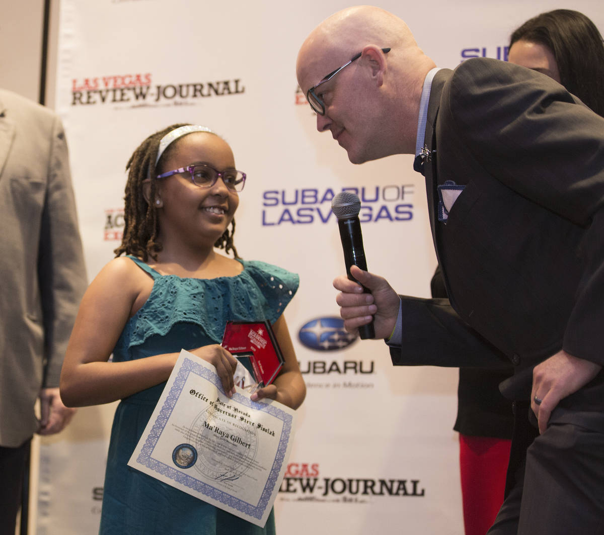 Ma’Raya Gilbert, left, a third grader at Silver Sands Montessori, receives her award dur ...