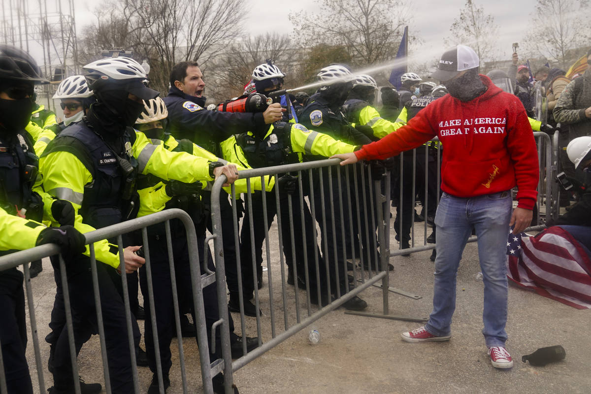 Demonstators loyal to President Donald Trump, are sprayed by police, Wednesday, Jan. 6, 2021, d ...