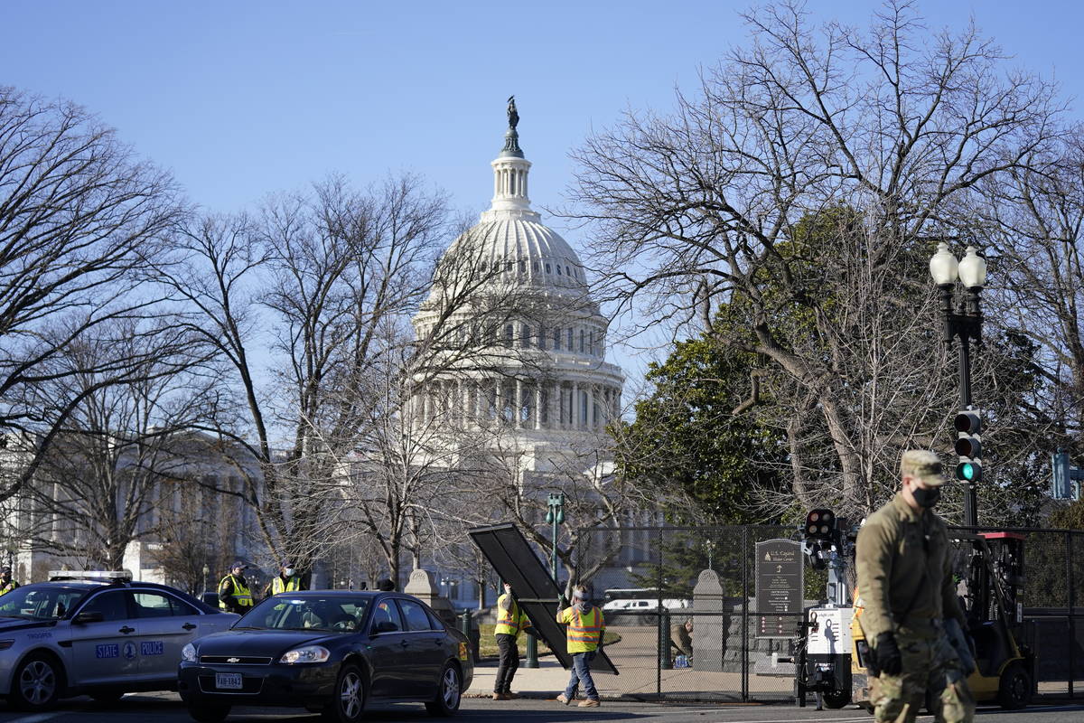 Workers install no-scale fencing around the U.S. Capitol in Washington, Thursday, Jan. 7, 2021. ...