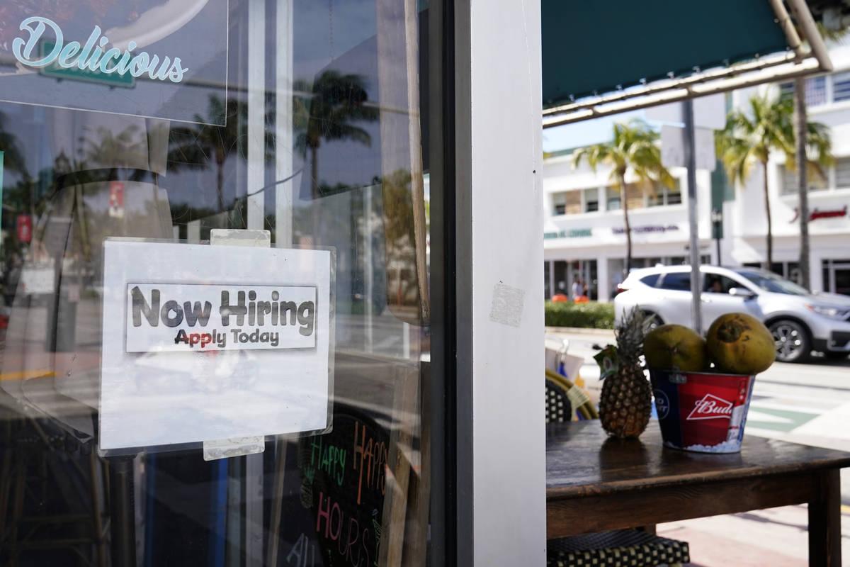 A "Now Hiring," sign is shown in the window of a restaurant, Thursday, Jan. 7, 2021, ...