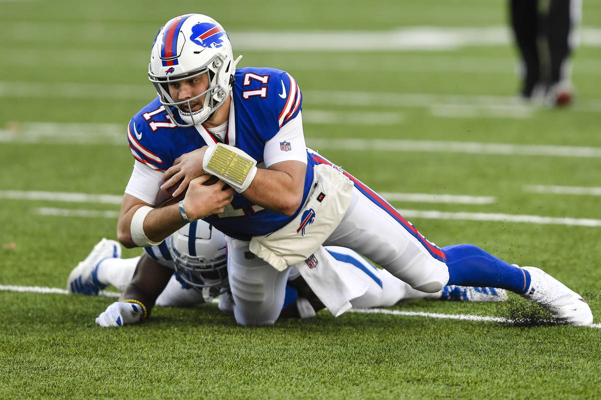 Buffalo Bills quarterback Josh Allen (17) is tackled by Indianapolis Colts' Kenny Moore II duri ...