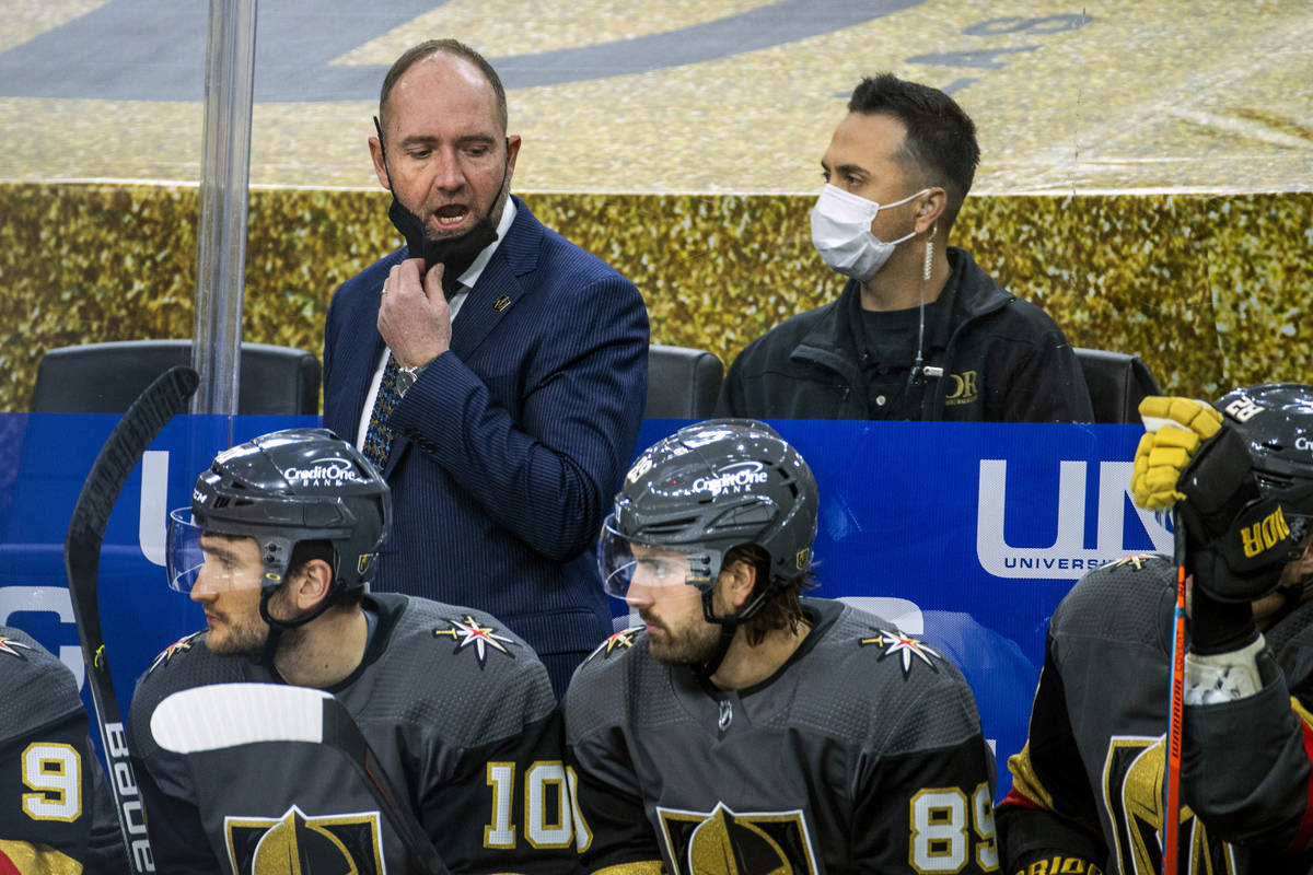 Golden Knights head coach Peter DeBoer yells instructions to his players on the bench versus th ...