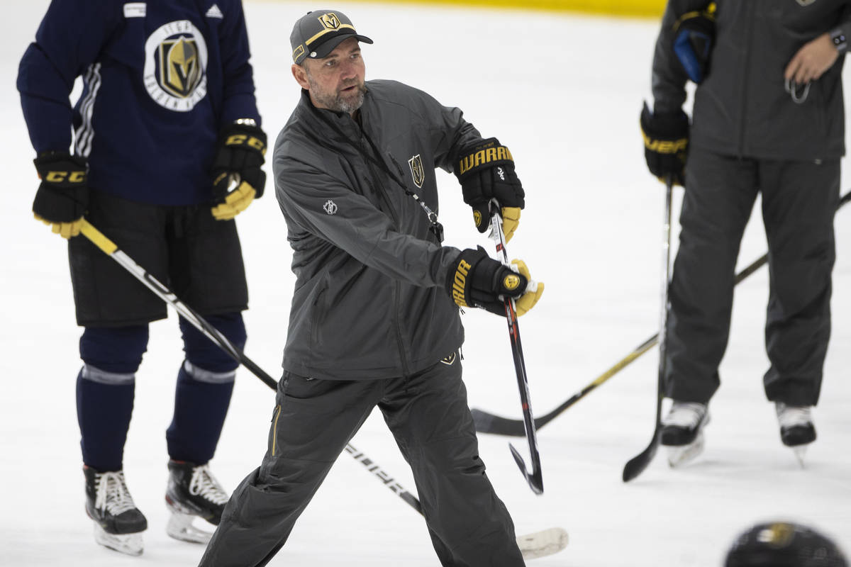 Golden Knights head coach Peter DeBoer gives direction to his players during practice at City N ...