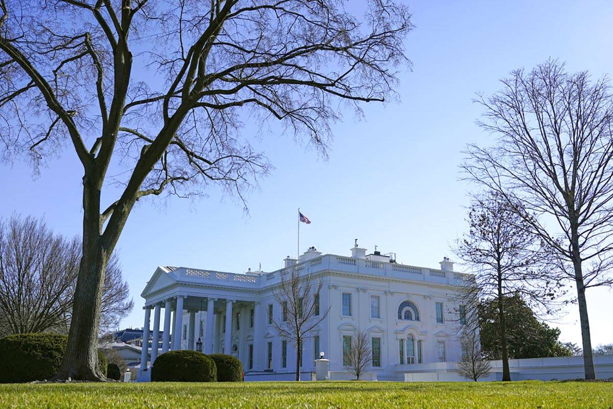 An American flag flies above the White House in Washington, Sunday, Jan. 10, 2021. (AP Photo/Pa ...