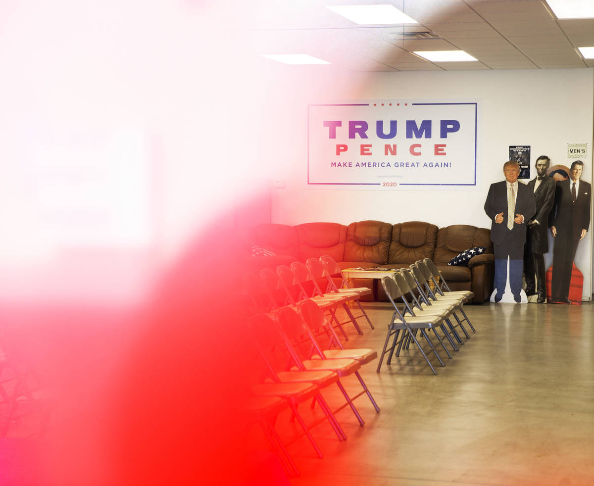 A cardboard cutout of President Trump, left, seen from the window of the Nye County Republican ...