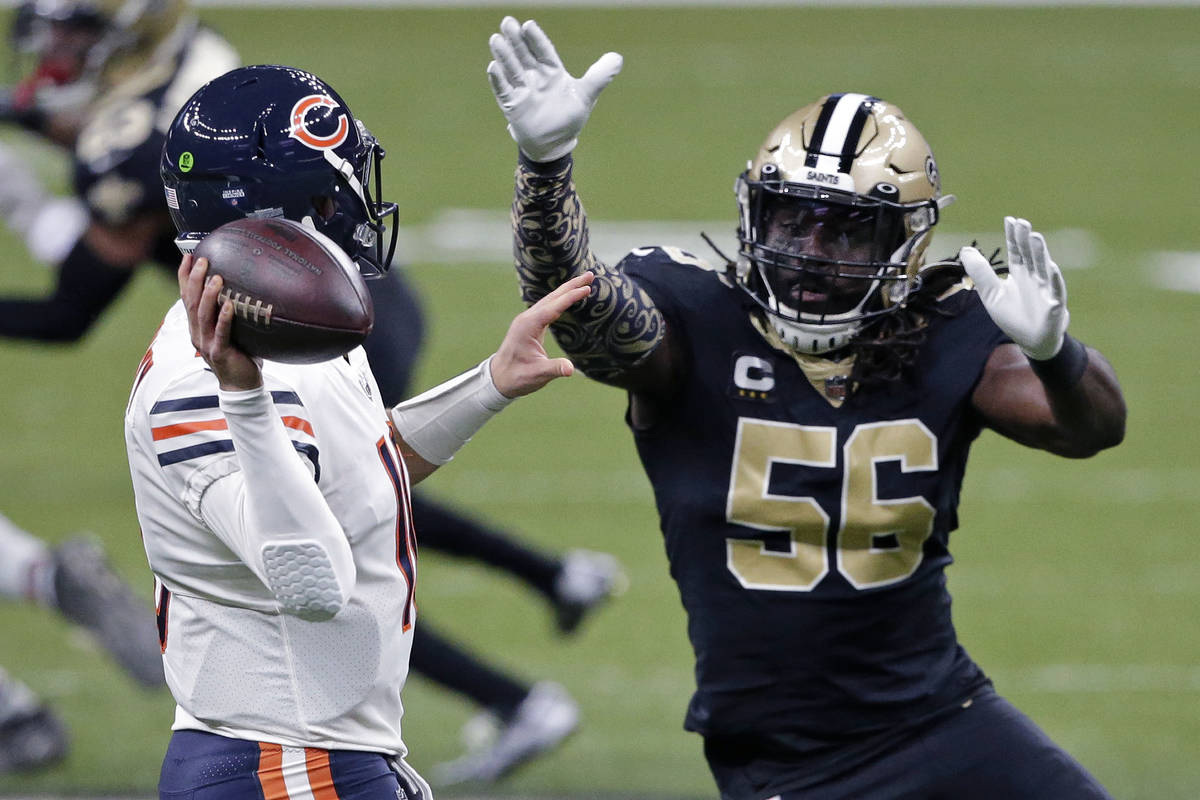 Chicago Bears quarterback Mitchell Trubisky passes under pressure from New Orleans Saints outsi ...