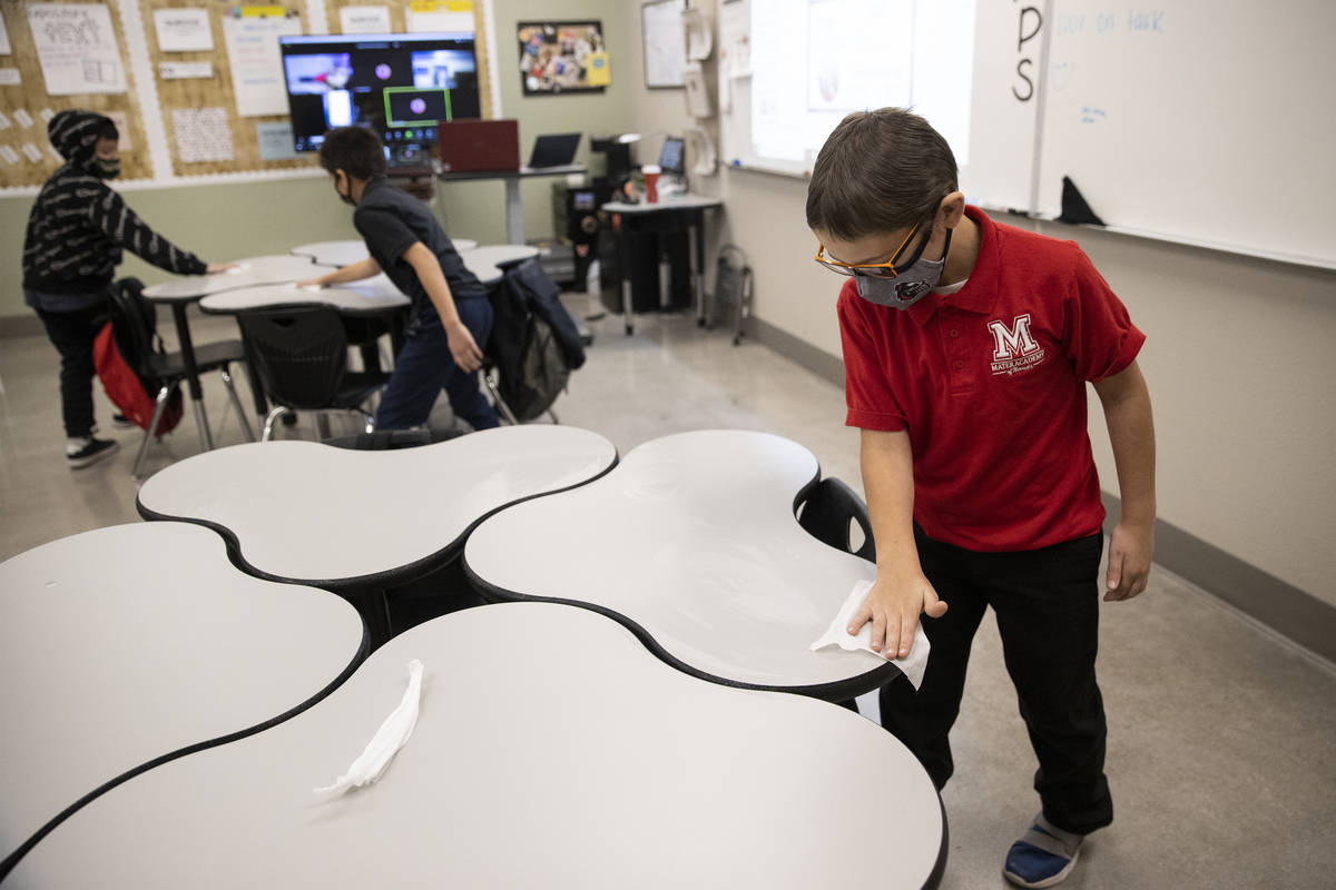 Daniel Saunders wipes down his desk at the end of his class at Mater Academy East Campus in Las ...