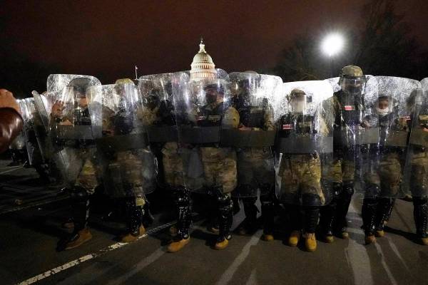 DC National Guard stand outside the Capitol, Wednesday, Jan. 6, 2021, after a day of rioting pr ...