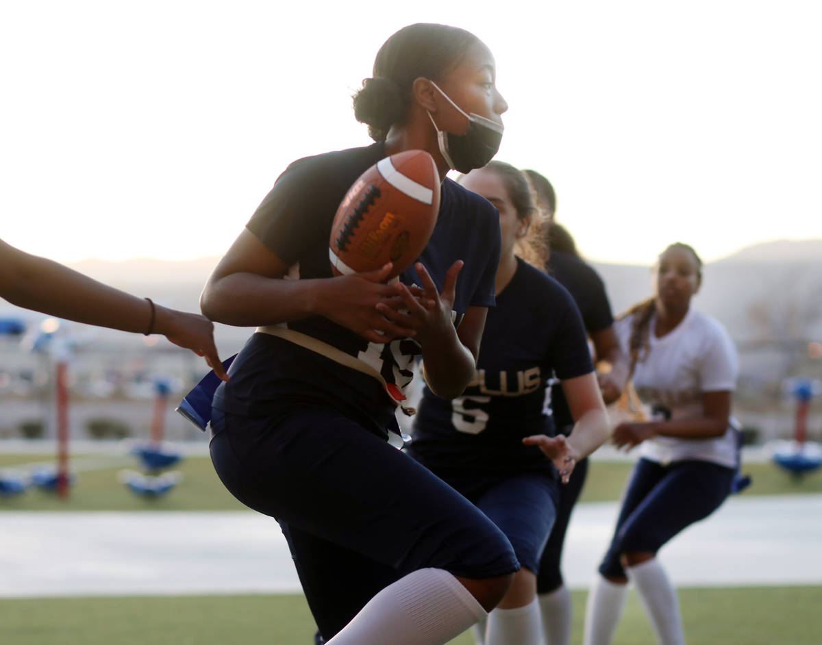 Tiani Moore, 15, wide receiver, catches the ball during flag football practice at Amplus High S ...