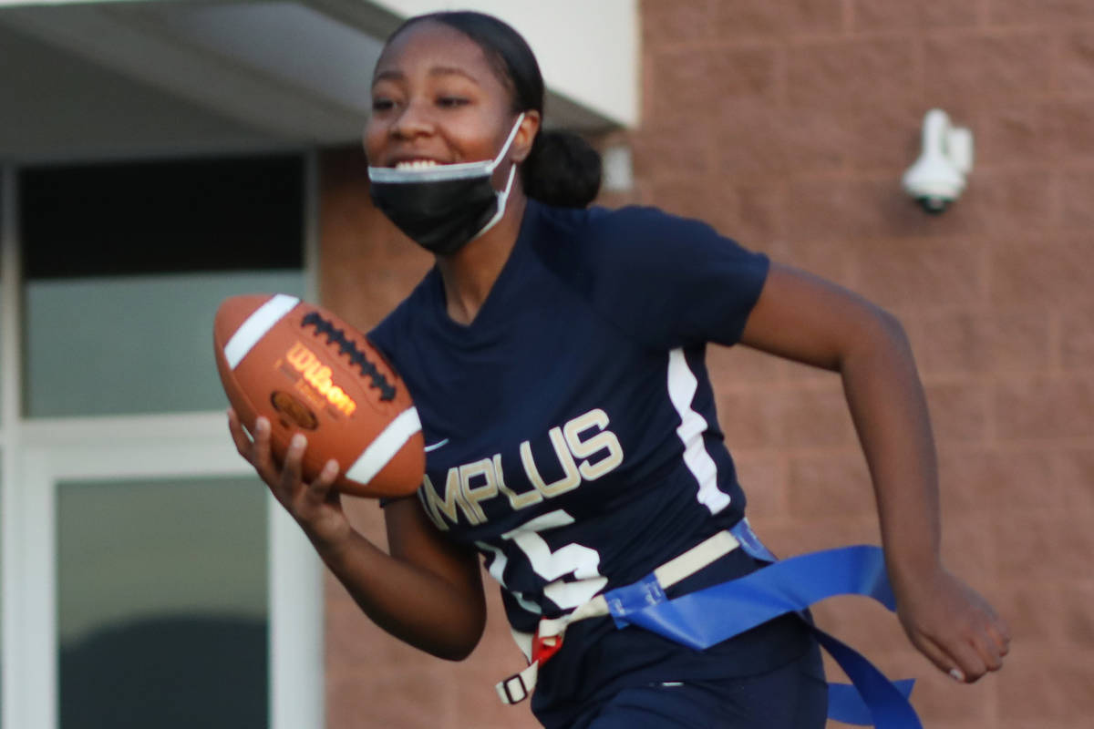 Tiani Moore, 15, wide receiver, runs the ball during flag football practice at Amplus High Scho ...