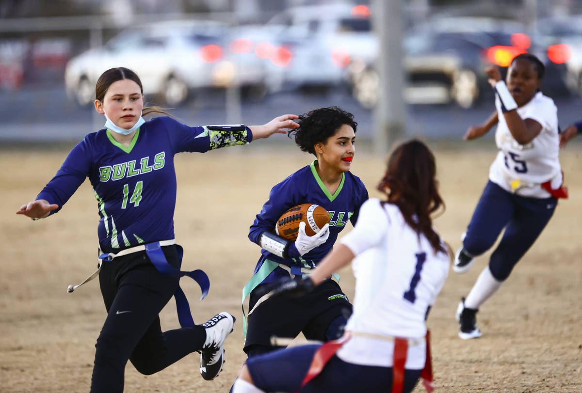 SLAM! Nevada's Iris Cardoza runs the ball against Amplus Academy during a flag football game at ...