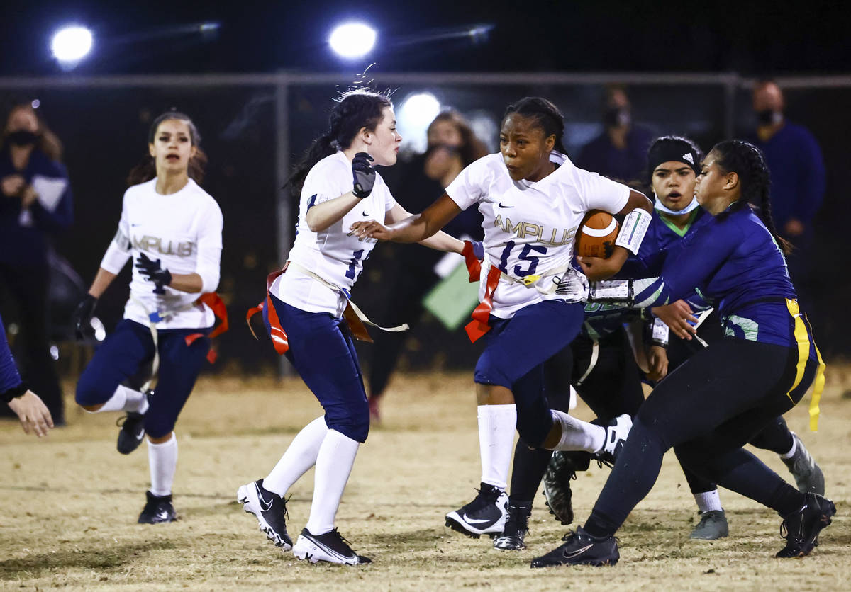 Amplus Academy Tiani Moore (15) tries to break through SLAM! Nevada defense during a flag footb ...