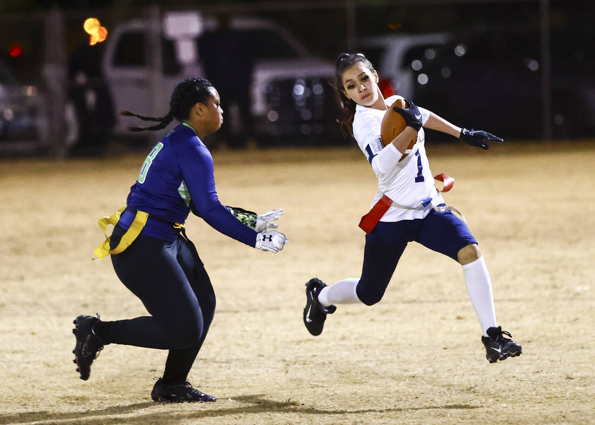 Amplus Academy's Karina Hudzenko (1) runs the ball past SLAM! Nevada's Sasha Ia during a flag f ...