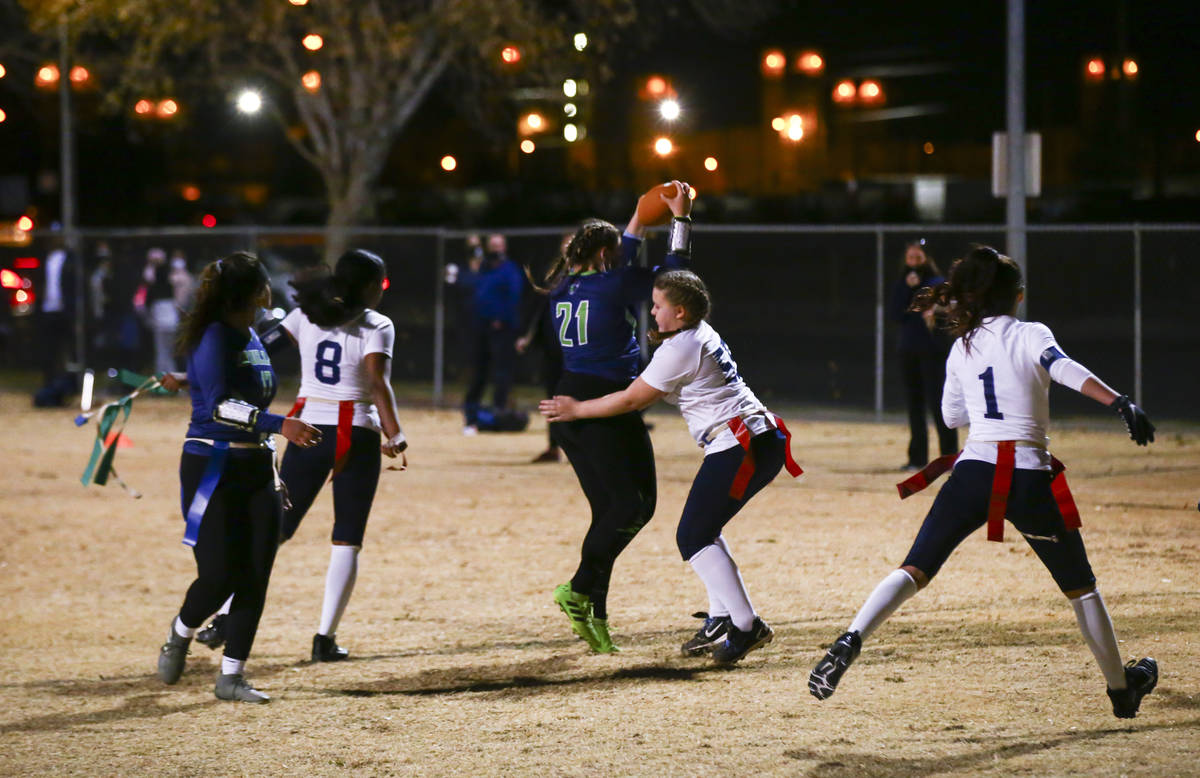 SLAM! Nevada's Sydney Cox (21) scores a touchdown against Amplus Academy during a flag football ...