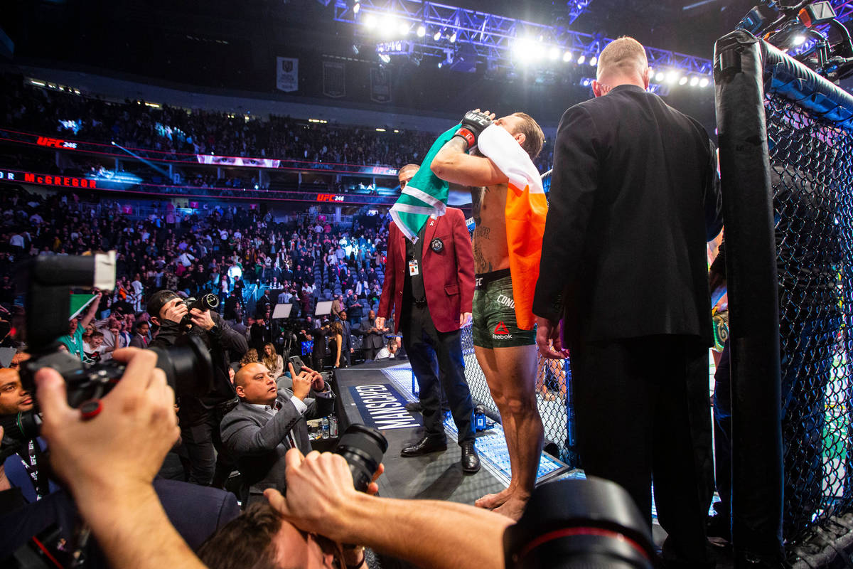Conor McGregor motions to the crowd after defeating Donald "Cowboy" Cerrone via technical knock ...