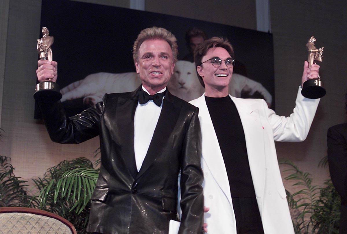 Las Vegas legends Siegfried, left, and Roy show their Merlin statuettes after being named Magic ...