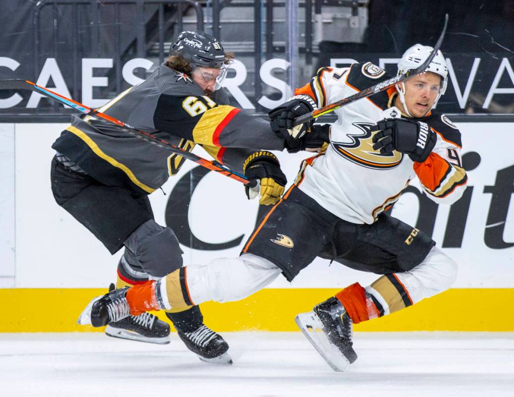 Golden Knights right wing Mark Stone (61) checks Anaheim Ducks defenseman Hampus Lindholm (47) ...