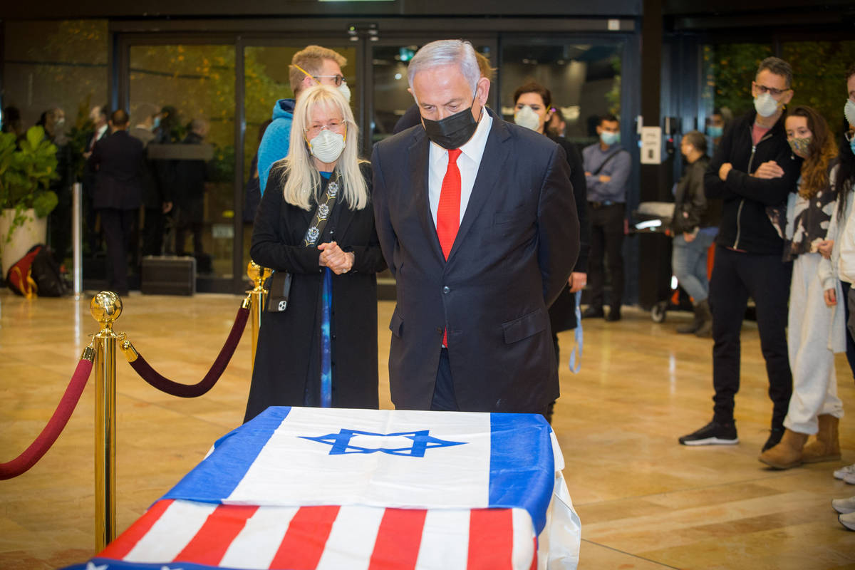 Israeli Prime Minister Benjamin Netanyahu pays his respects to Sheldon Adelson on Thursday, Jan ...