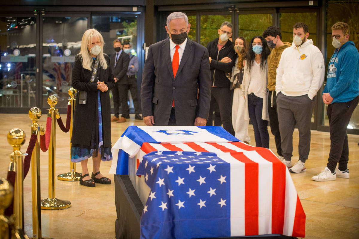 Israeli Prime Minister Benjamin Netanyahu pays his respects to Sheldon Adelson on Thursday, Jan ...