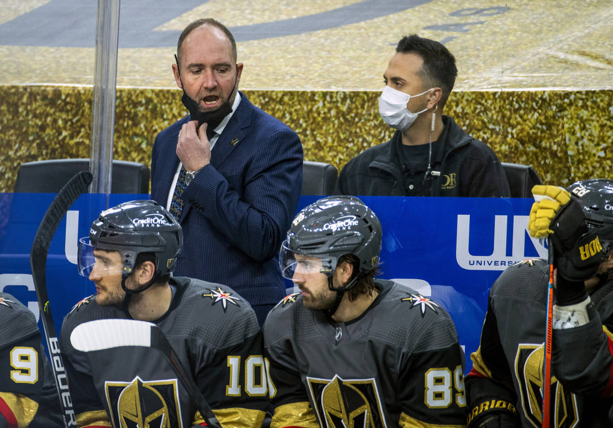 Golden Knights head coach Peter DeBoer yells instructions to his players on the bench versus th ...