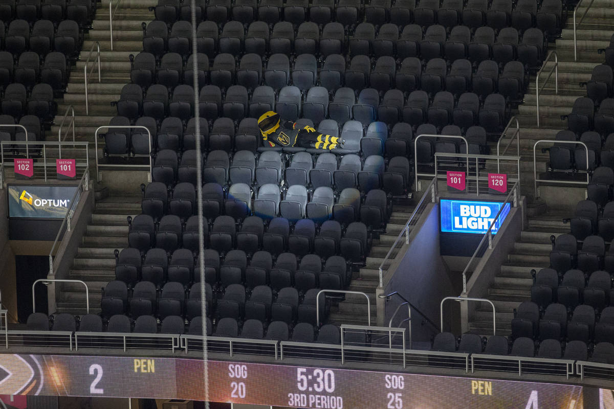 Vegas Golden Knights mascot Chance lays out across empty seats during the third period of an NH ...